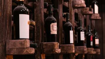A wine cellar with wooden racks holding bottles of wine.