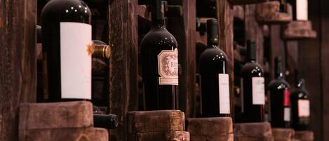 A wine cellar with wooden racks holding bottles of wine.