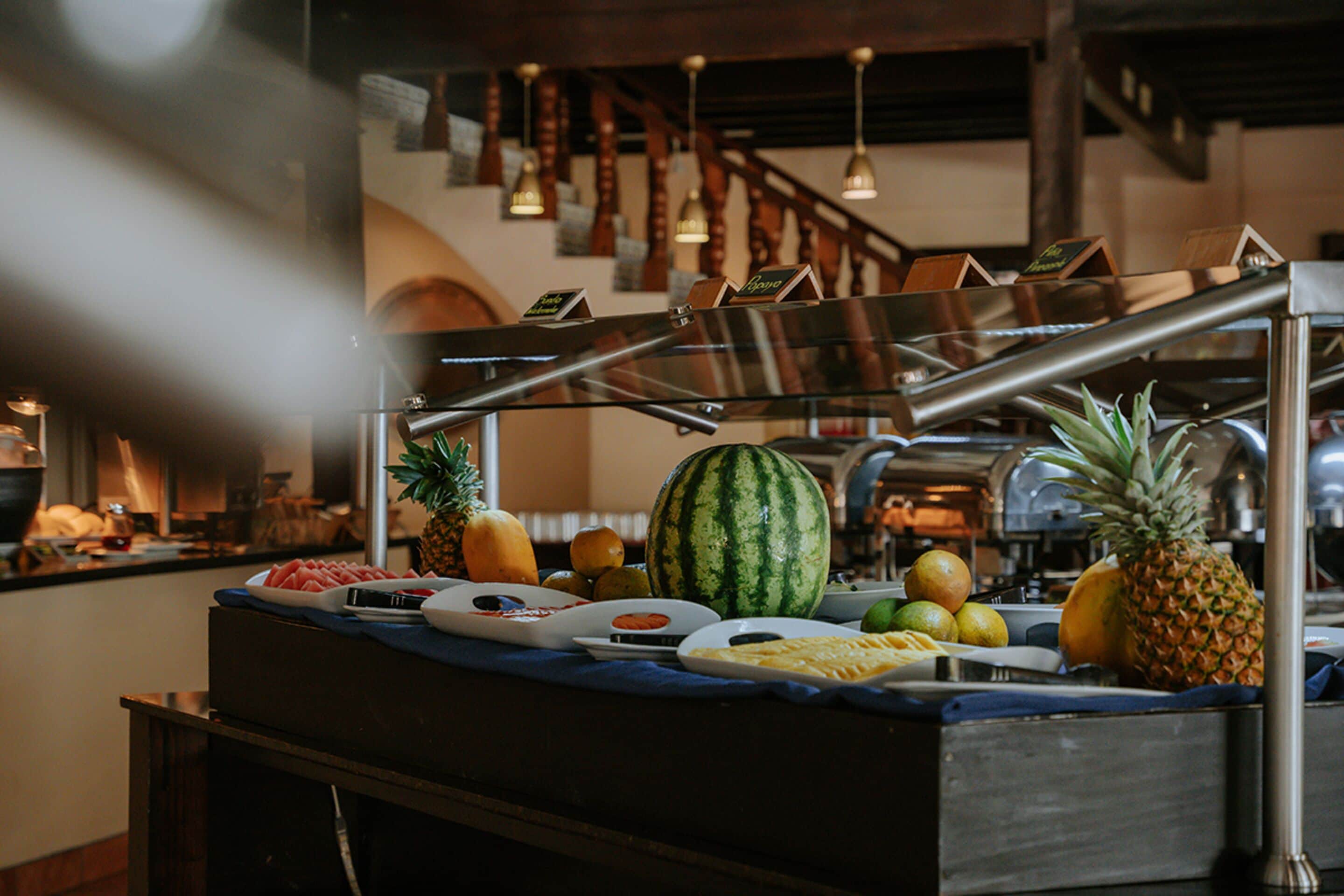 A buffet with various fruits and dishes.