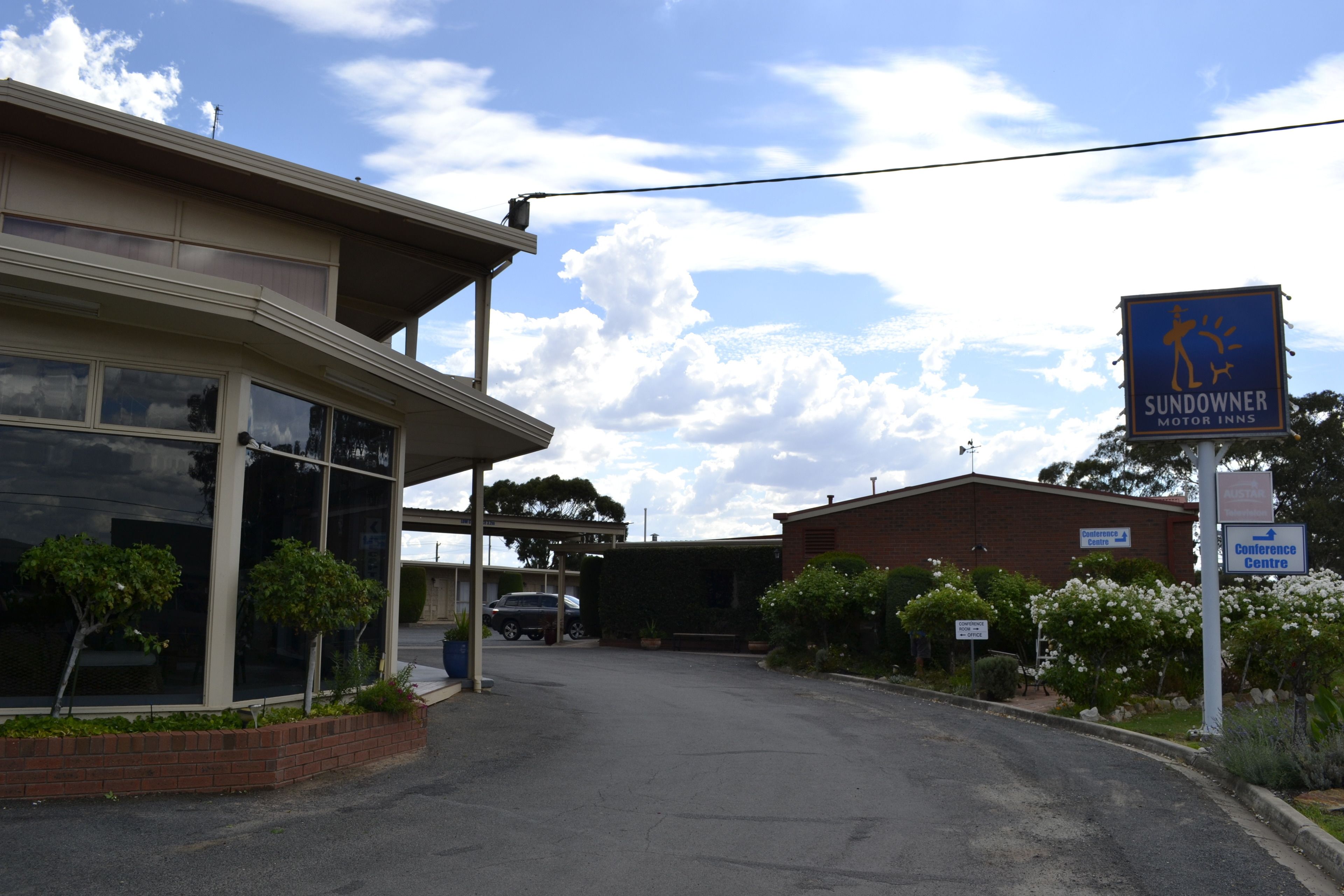 A building with a sign for 'Sundowner Motor Inns' and a 'Conference Centre' sign.