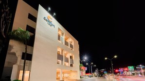 A hotel with a modern facade, multiple balconies, and a well-lit entrance. - Comfort Inn Tampico (Tampico)