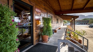 A wooden building with an 'Office' sign, a welcoming 'Welcome' sign, and a 'Pull' sign.