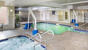 An indoor swimming pool with multiple lanes, a hot tub, and a lifeguard station. - Hilton Garden Inn Hampton Coliseum Central (Hampton)