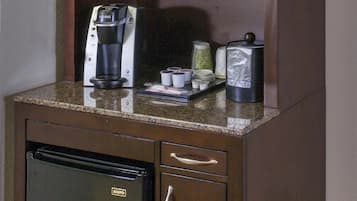 A kitchenette with a microwave, coffee maker, and a refrigerator.