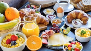 A breakfast spread with various foods and drinks. - Holiday Inn & Suites Bakersfield by IHG (Bakersfield)