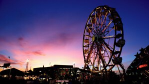 A Ferris wheel at dusk with a colorful sky in the background. - Holiday Inn & Suites Bakersfield by IHG (Bakersfield)