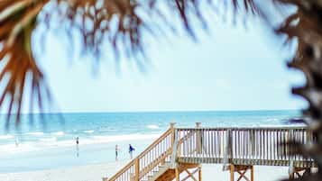 On the beach, white sand, sun-loungers, beach umbrellas