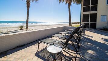 On the beach, white sand, sun loungers, beach umbrellas