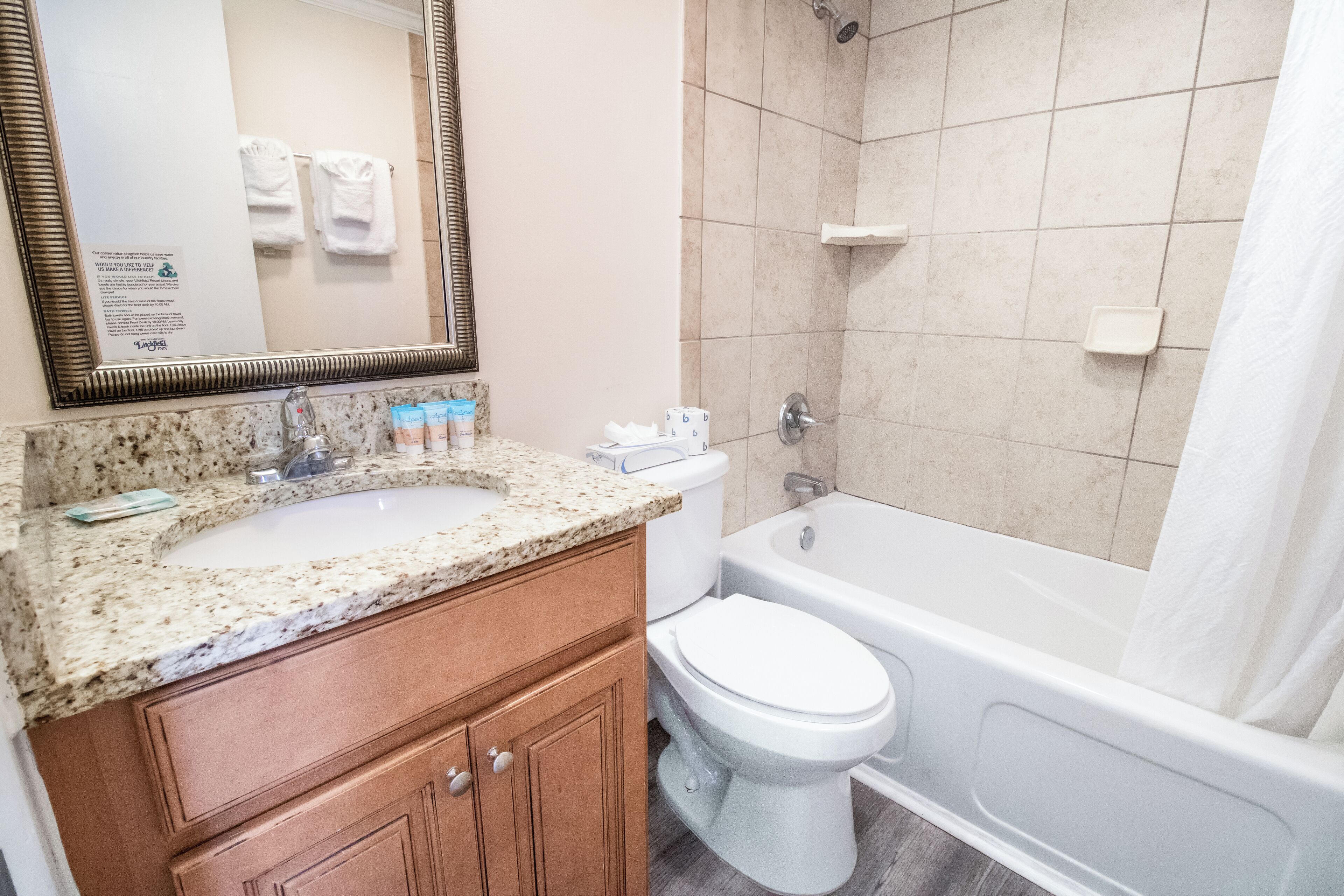 A bathroom with a sink, toilet, and bathtub.