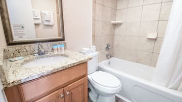 A bathroom with a sink, toilet, and bathtub.