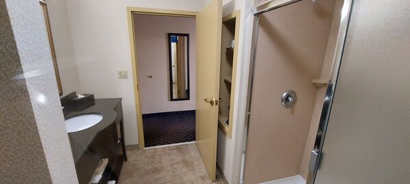 A bathroom with a sink, mirror, and shower door. - Hampton Inn Clearfield (Clearfield)