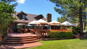 A patio area with outdoor seating, a stone staircase, and a stone chimney. - Lodge At Sedona (Sedona)