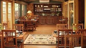 A cozy, rustic interior with wooden furniture and a bar area. - Lodge At Sedona (Sedona)