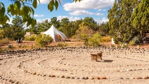 A campsite with a tent, a stone bench, and a circular arrangement of stones. - Lodge At Sedona (Sedona)