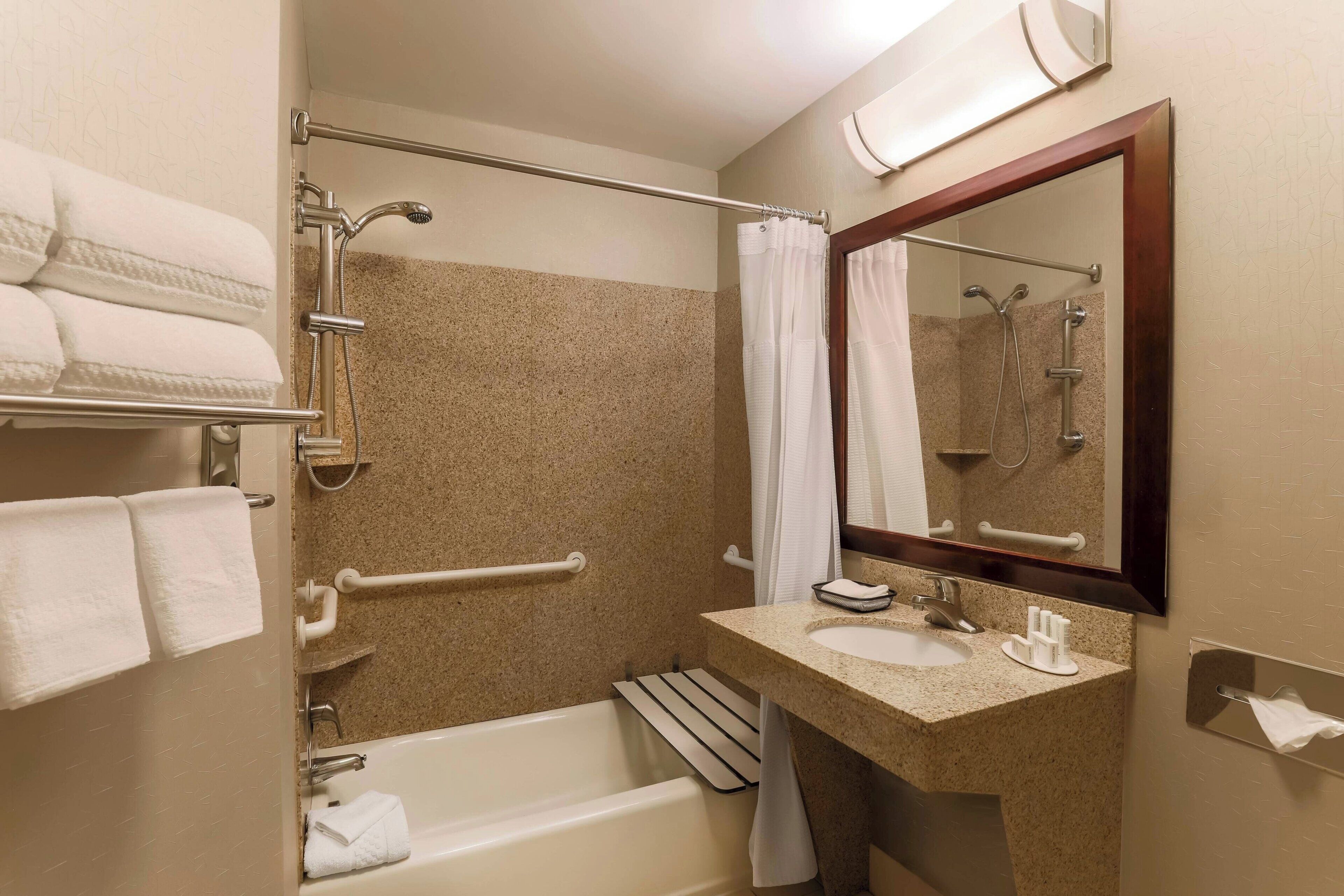 combined shower/bathtub, designer toiletries, hair dryer, towels