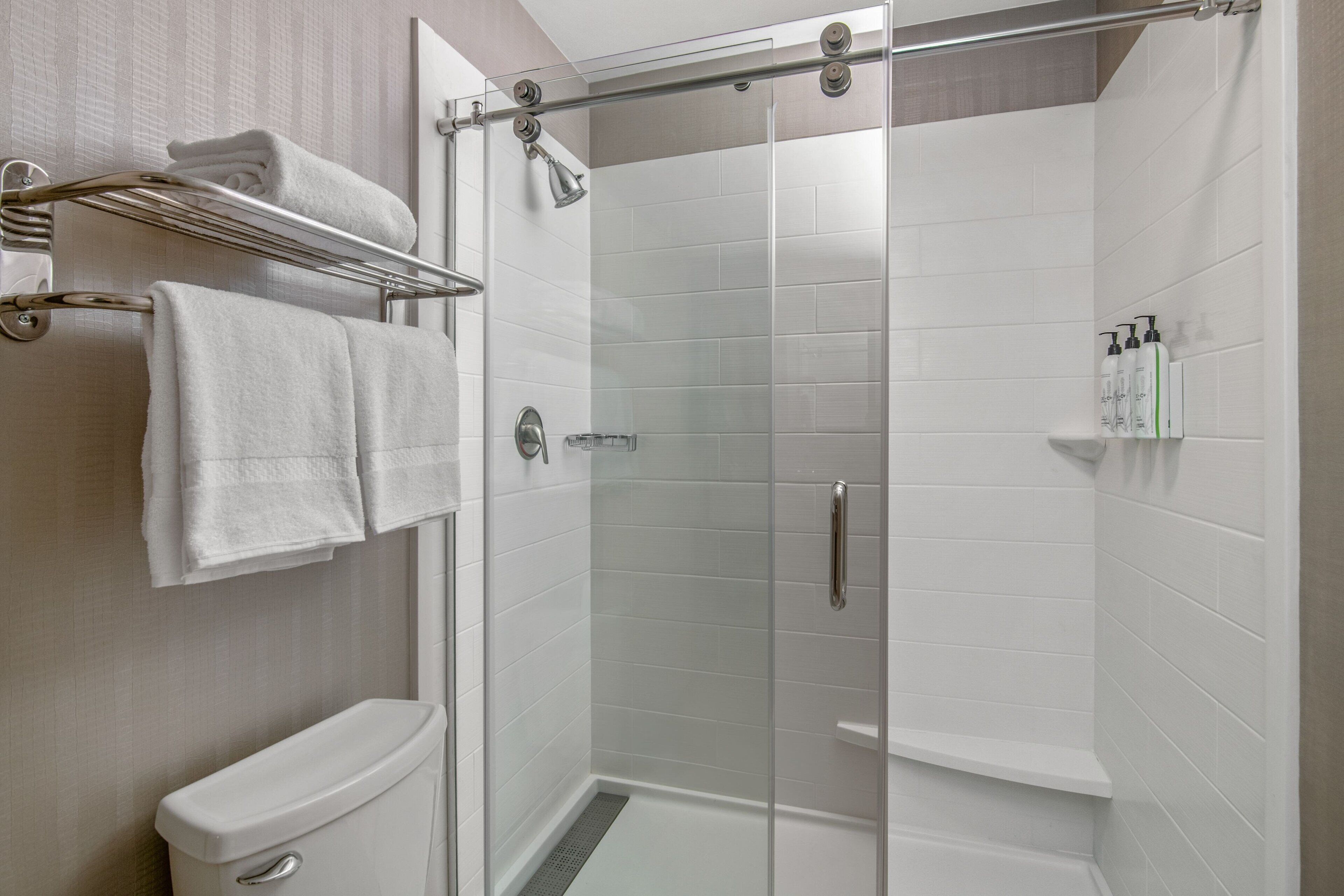 combined shower/bathtub, designer toiletries, hair dryer, towels