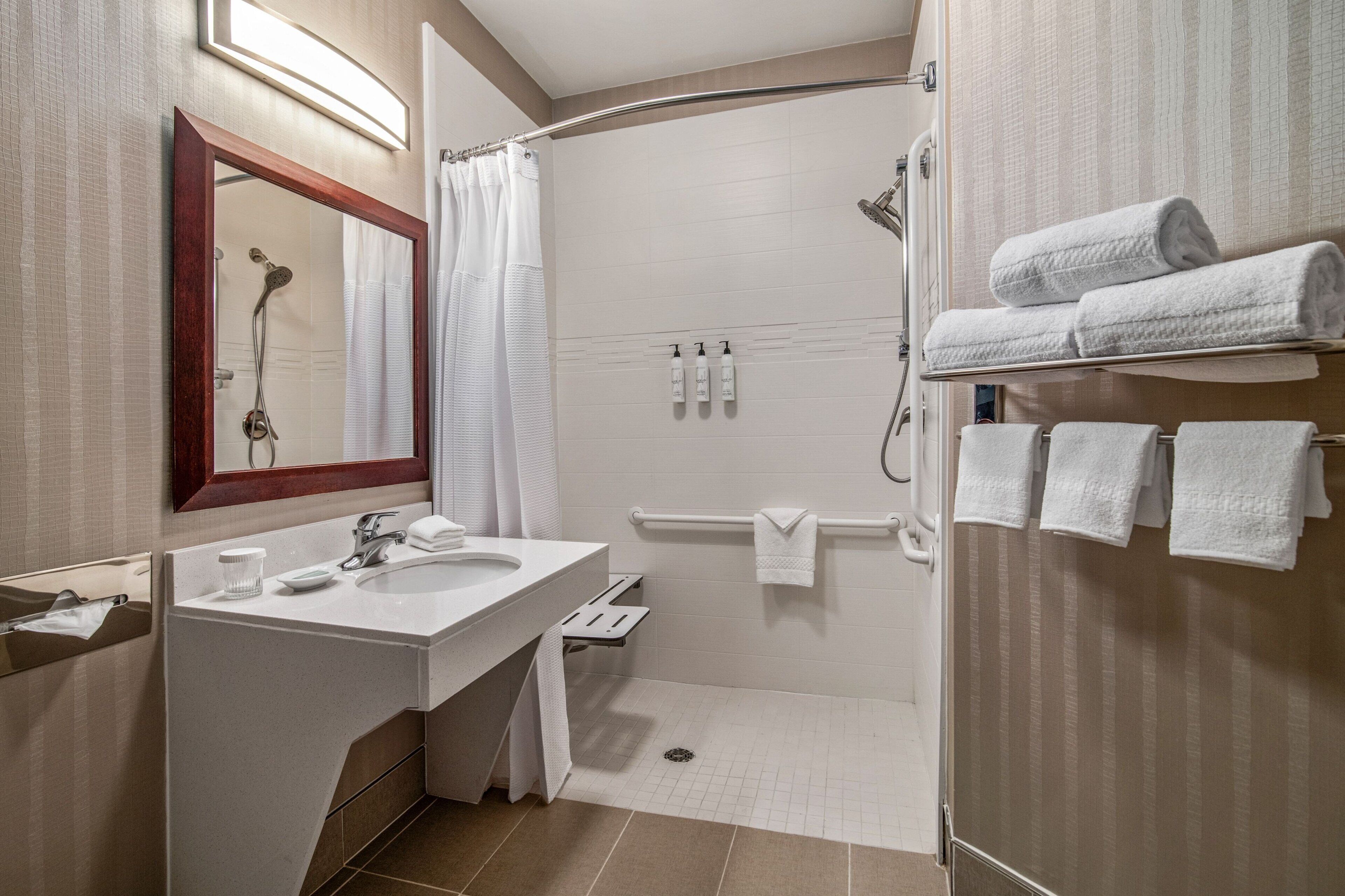 combined shower/bathtub, designer toiletries, hair dryer, towels