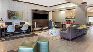 A modern hotel lobby with a reception desk, seating area, and a dining space. - Best Western Plus Duncanville/Dallas (Duncanville)