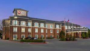A Best Western Plus hotel with a brick facade, multiple windows, and a parking lot. - Best Western Plus Duncanville/Dallas (Duncanville)
