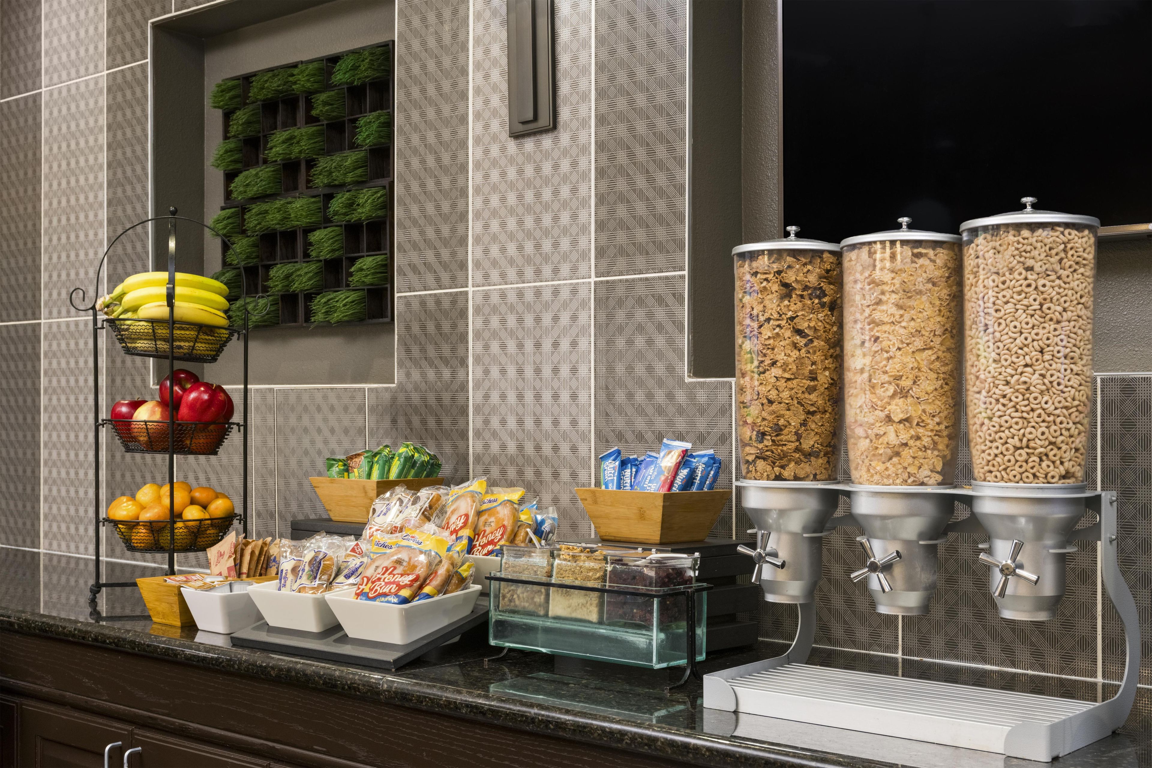 A breakfast bar with various food items and a coffee machine.