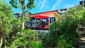 A building with a red roof, surrounded by lush greenery. - Cinnamon Beach Villas (Koh Samui)