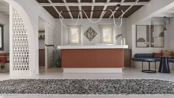 A modern kitchen with a wooden countertop, a white backsplash, and pendant lighting.