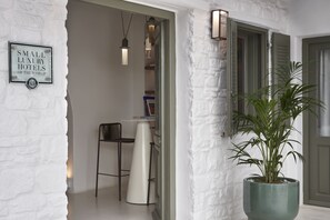 A white brick wall with a sign reading "Small Luxury Hotels of the World."