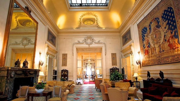 A grand lobby with ornate decor, a large chandelier, and a patterned carpet. - Luton Hoo Hotel, Golf And Spa (Luton)