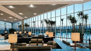 A spacious lobby with a pool view, modern seating, and large windows. - Jolie Ville Royal Peninsula Hotel & Resort Sharm El Sheikh (Sharm El Sheikh)