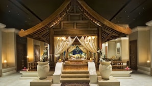 A traditional wooden structure with a tiered roof, a central platform with seating, and two large vases on pedestals. - Jolie Ville Royal Peninsula Hotel & Resort Sharm El Sheikh (Sharm El Sheikh)