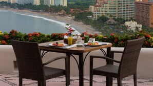 A table set for breakfast with a view of the beach and buildings in the background. - Pacífica Resort Ixtapa All-Inclusive (Ixtapa)