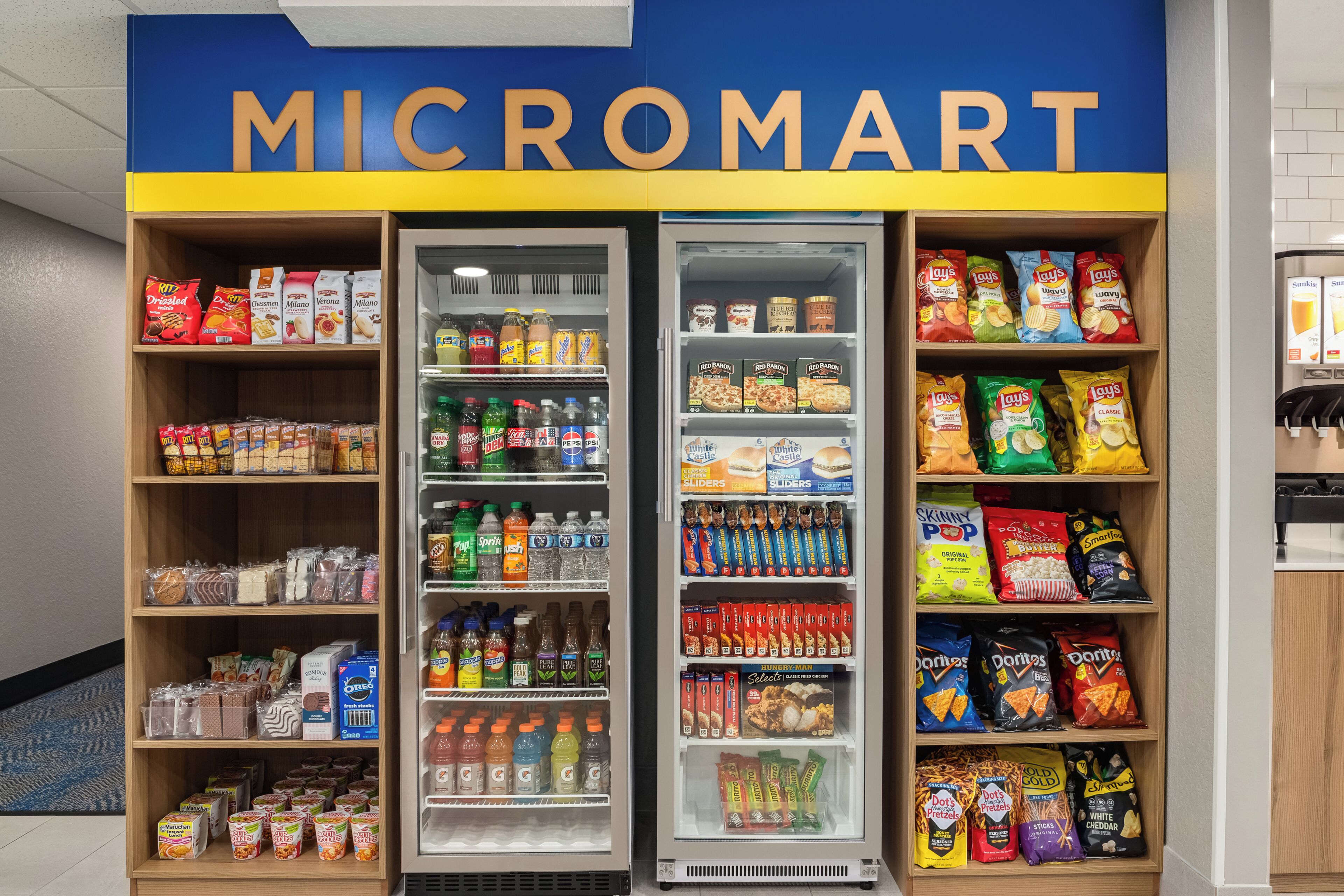 A Micromart with shelves stocked with snacks, beverages, and other groceries.