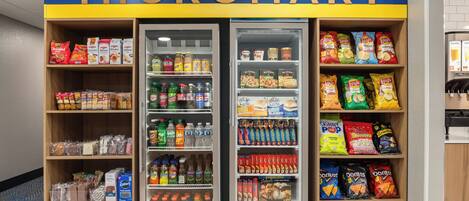 A Micromart with shelves stocked with snacks, beverages, and other groceries.