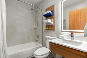 A modern bathroom with a bathtub, toilet, and sink. - Microtel Inn & Suites by Wyndham Culpeper (Culpeper)