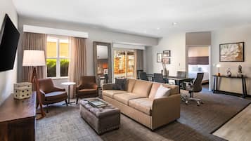 Premium bedding, desk, laptop workspace, blackout drapes