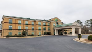 A large brick building with a green roof and a covered entrance area. - Holiday Inn Express & Suites Macon - I-475 By IHG (Macon)