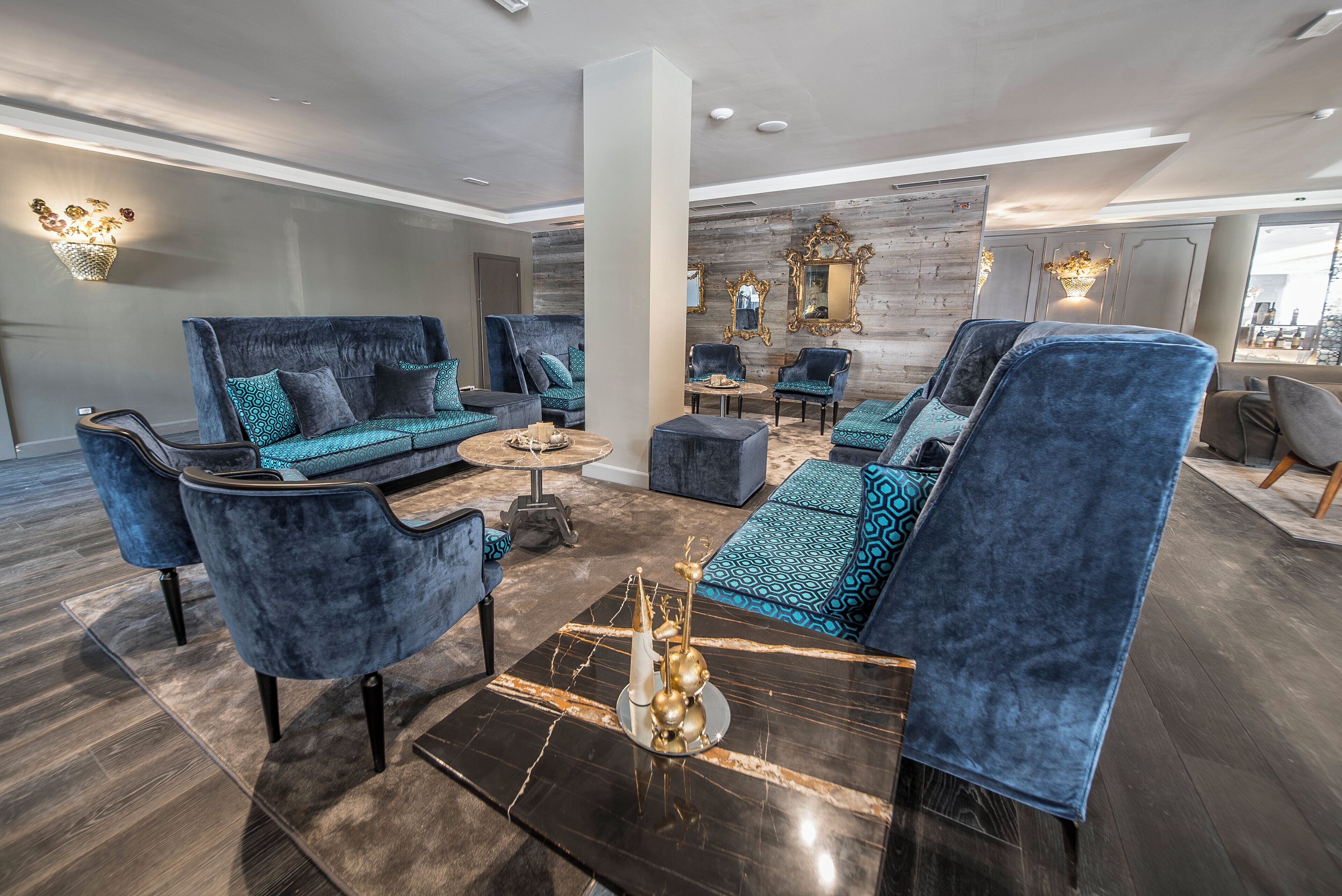 A modern living room with a sofa set, armchairs, and a coffee table.