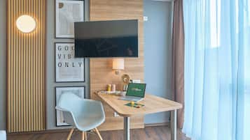 Hypo-allergenic bedding, desk, laptop workspace, blackout drapes