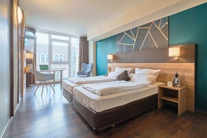 Hypo-allergenic bedding, desk, laptop workspace, blackout drapes