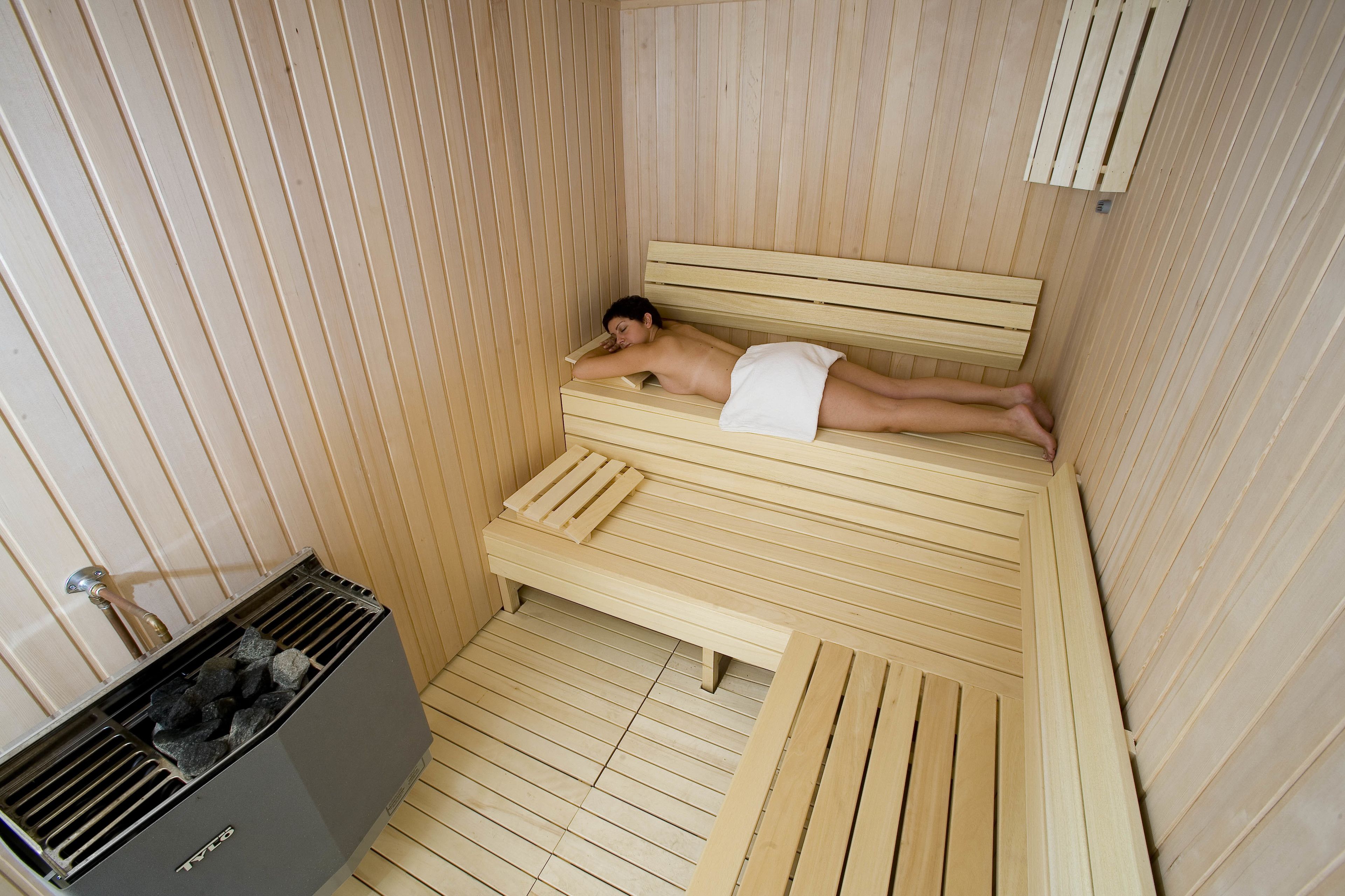 A sauna room with a wooden bench and benches.