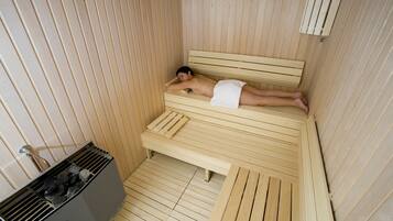 A sauna room with a wooden bench and benches.