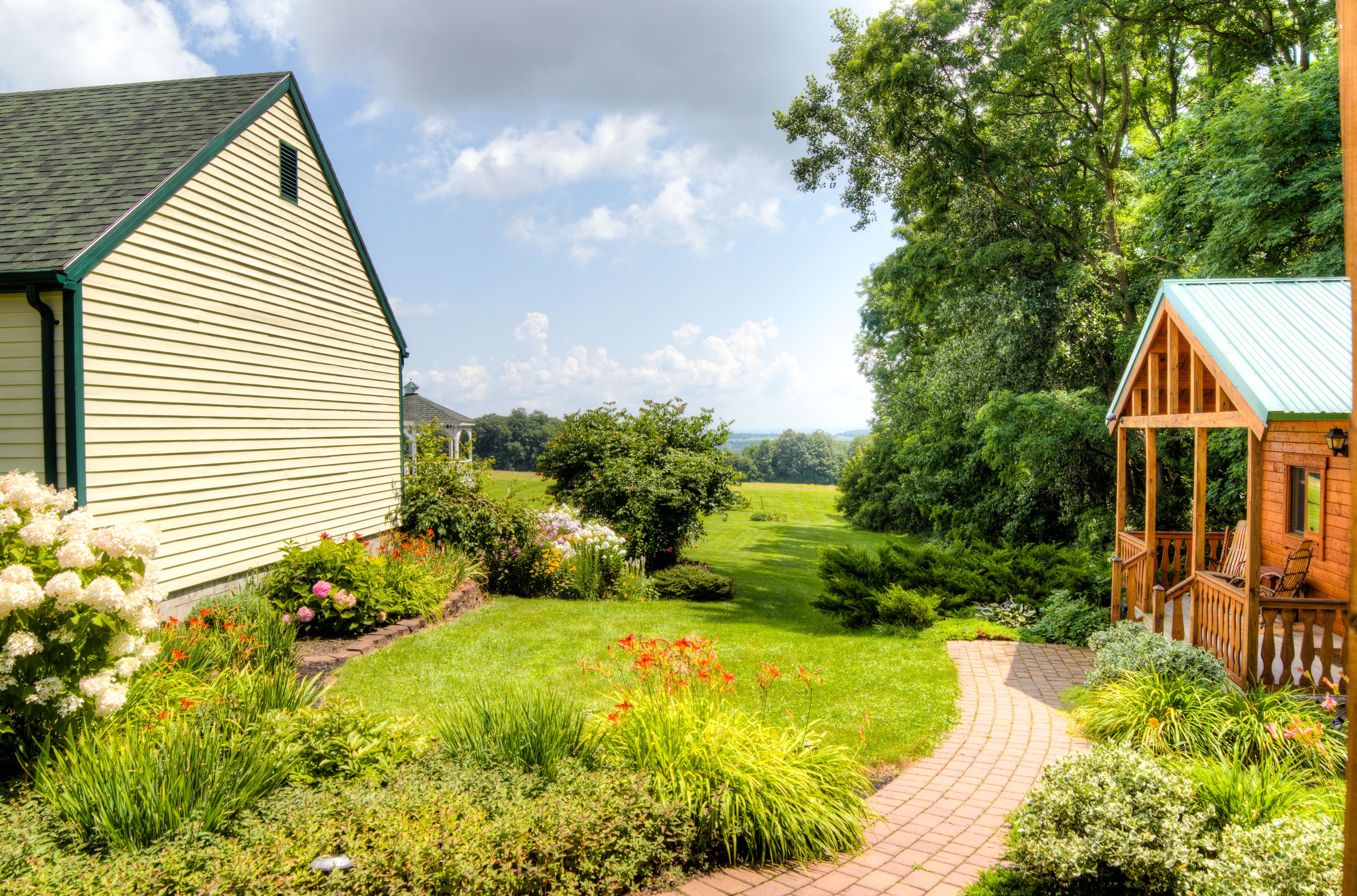 A house with a garden pathway leading to a wooden deck.