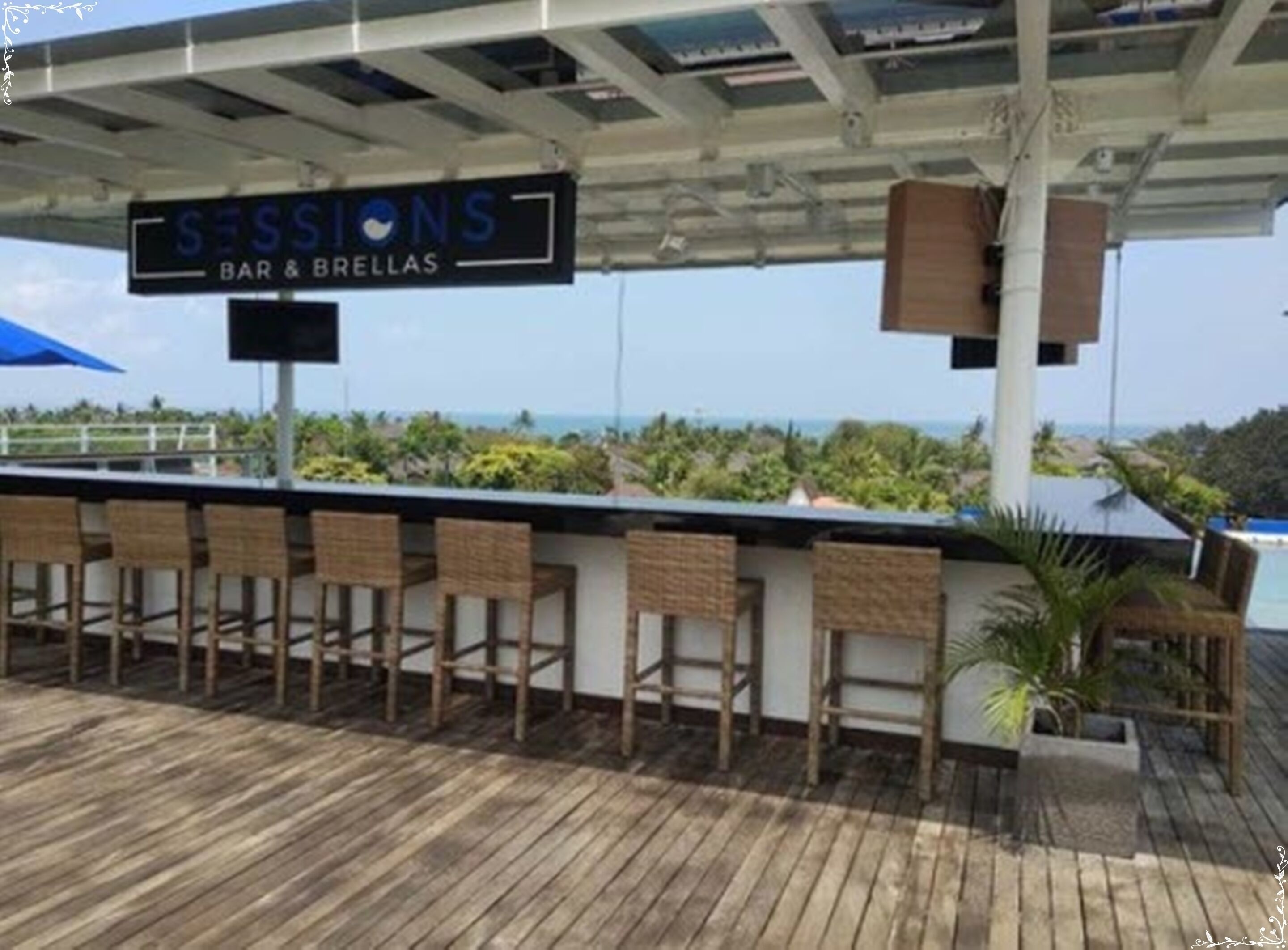 A bar area with a sign reading "SESSIONS BAR & BRELLAS" and wooden chairs.