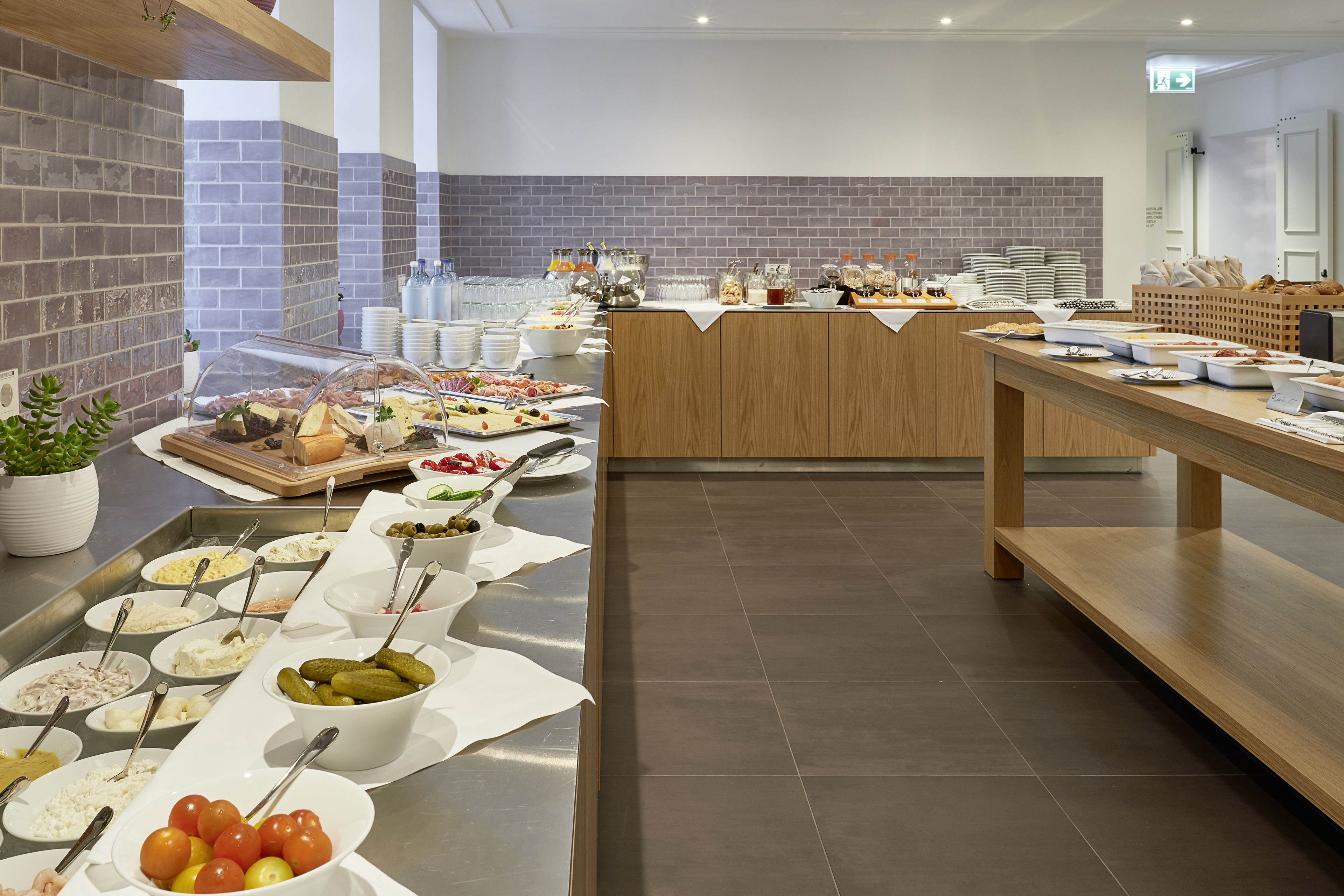 A buffet setup with various food items and utensils.
