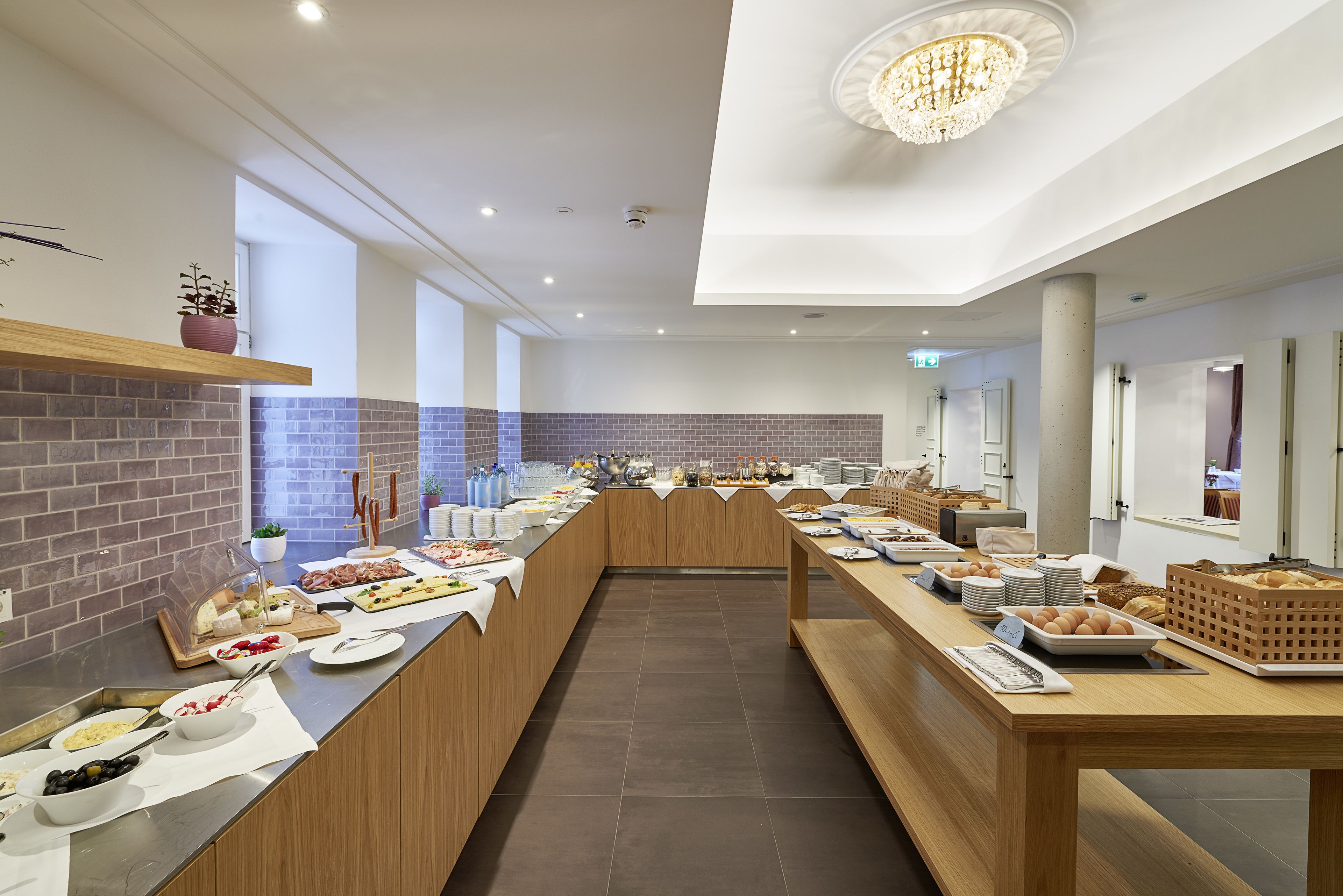 A modern breakfast buffet with various food items and a long counter.