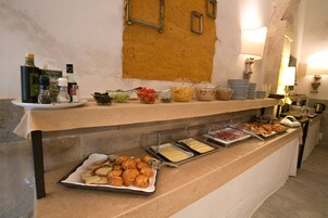 A buffet with various food items and condiments.