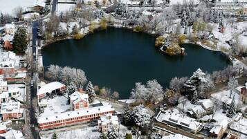 A snow-covered lake surrounded by residential buildings.