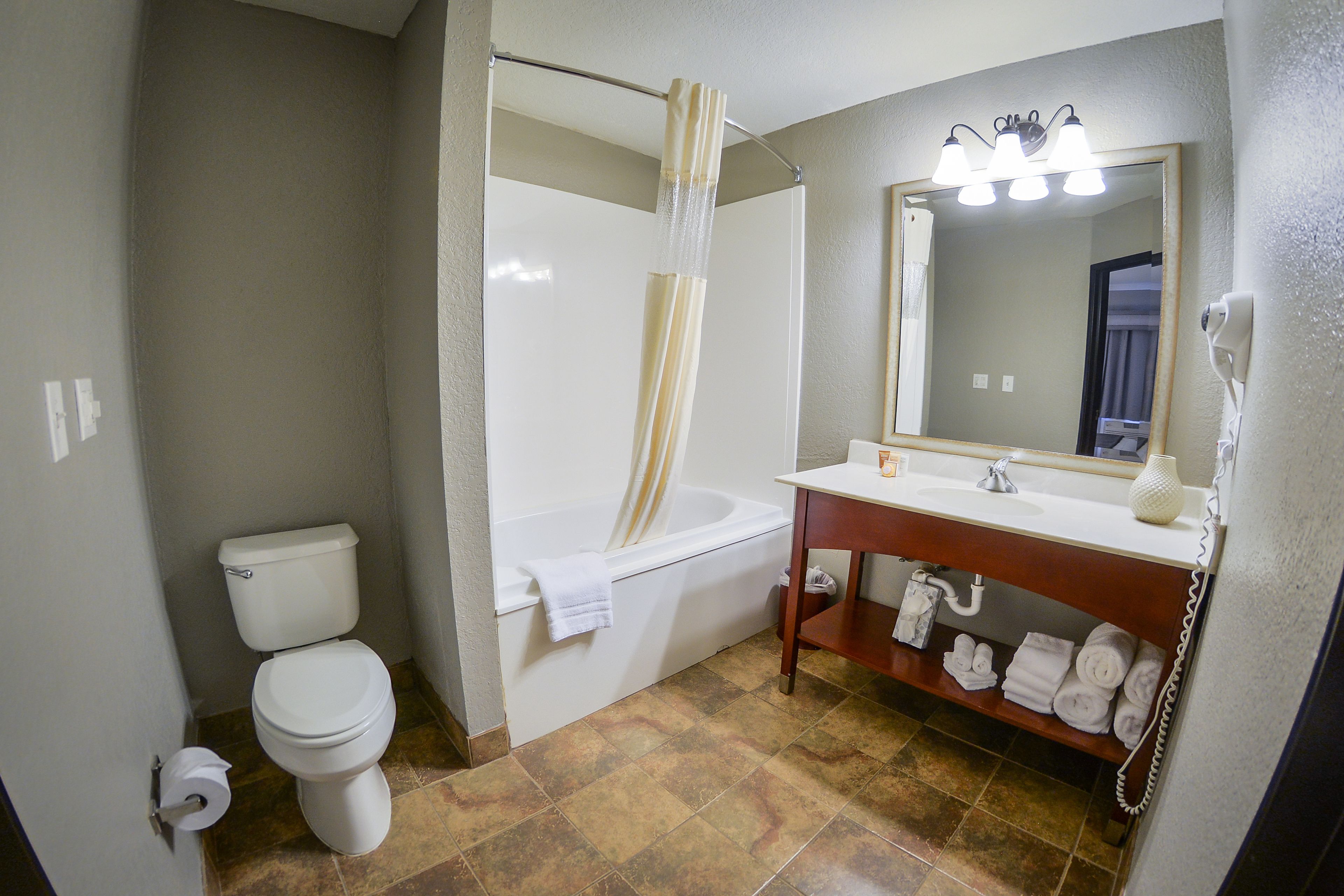 A bathroom with a toilet, bathtub, and sink.