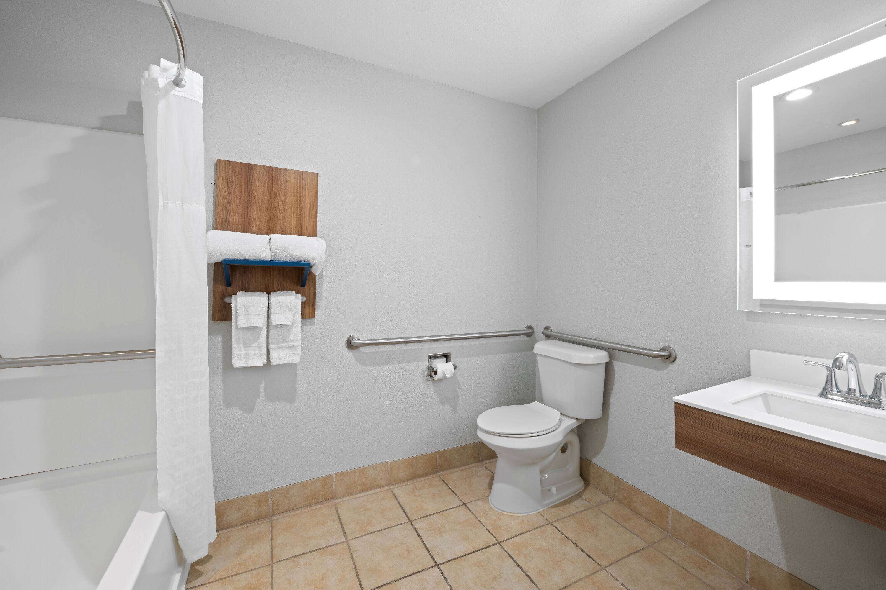 A bathroom with a toilet, sink, and shower.