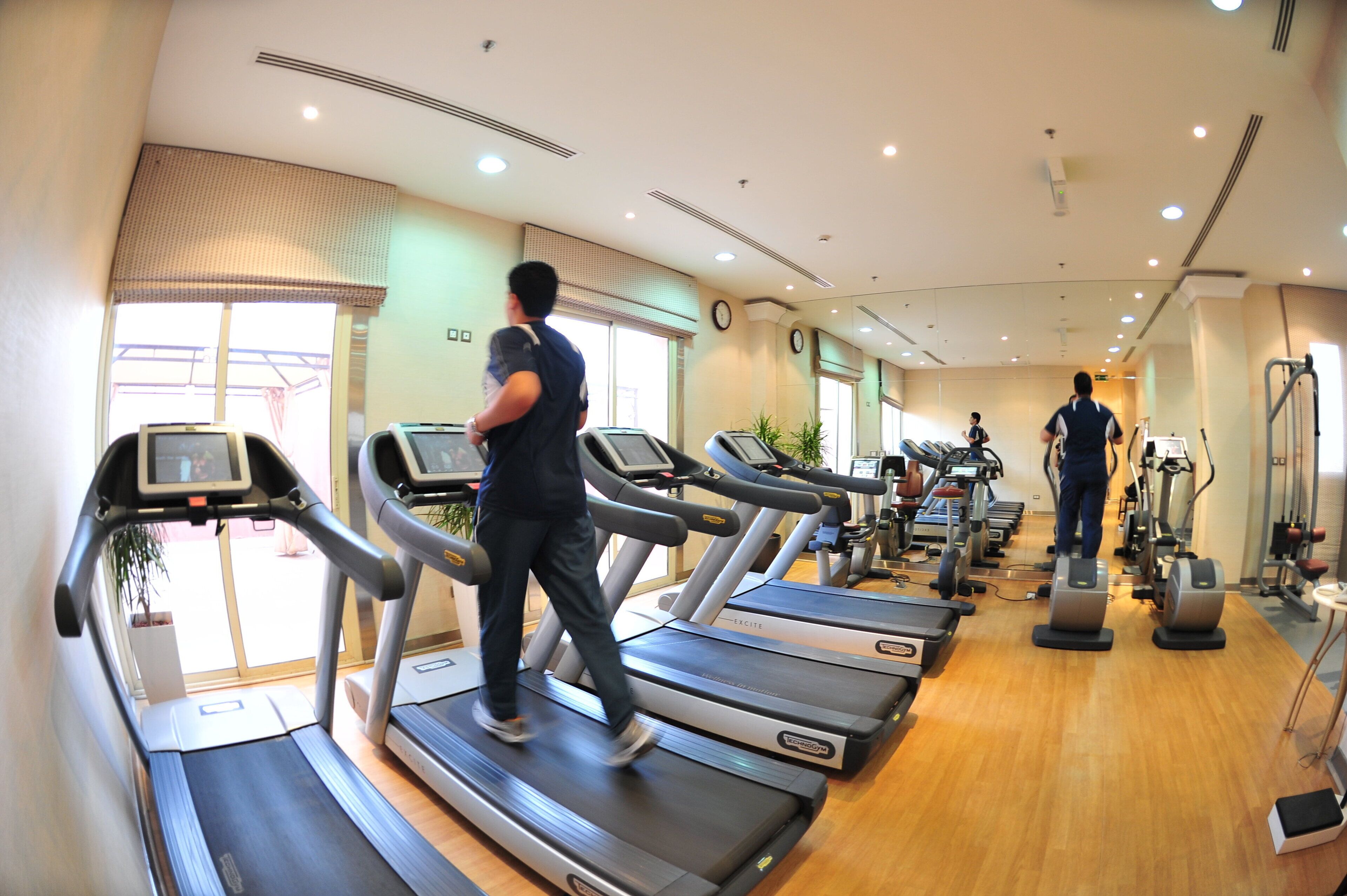 A gym with treadmills, exercise bikes, and other fitness equipment.